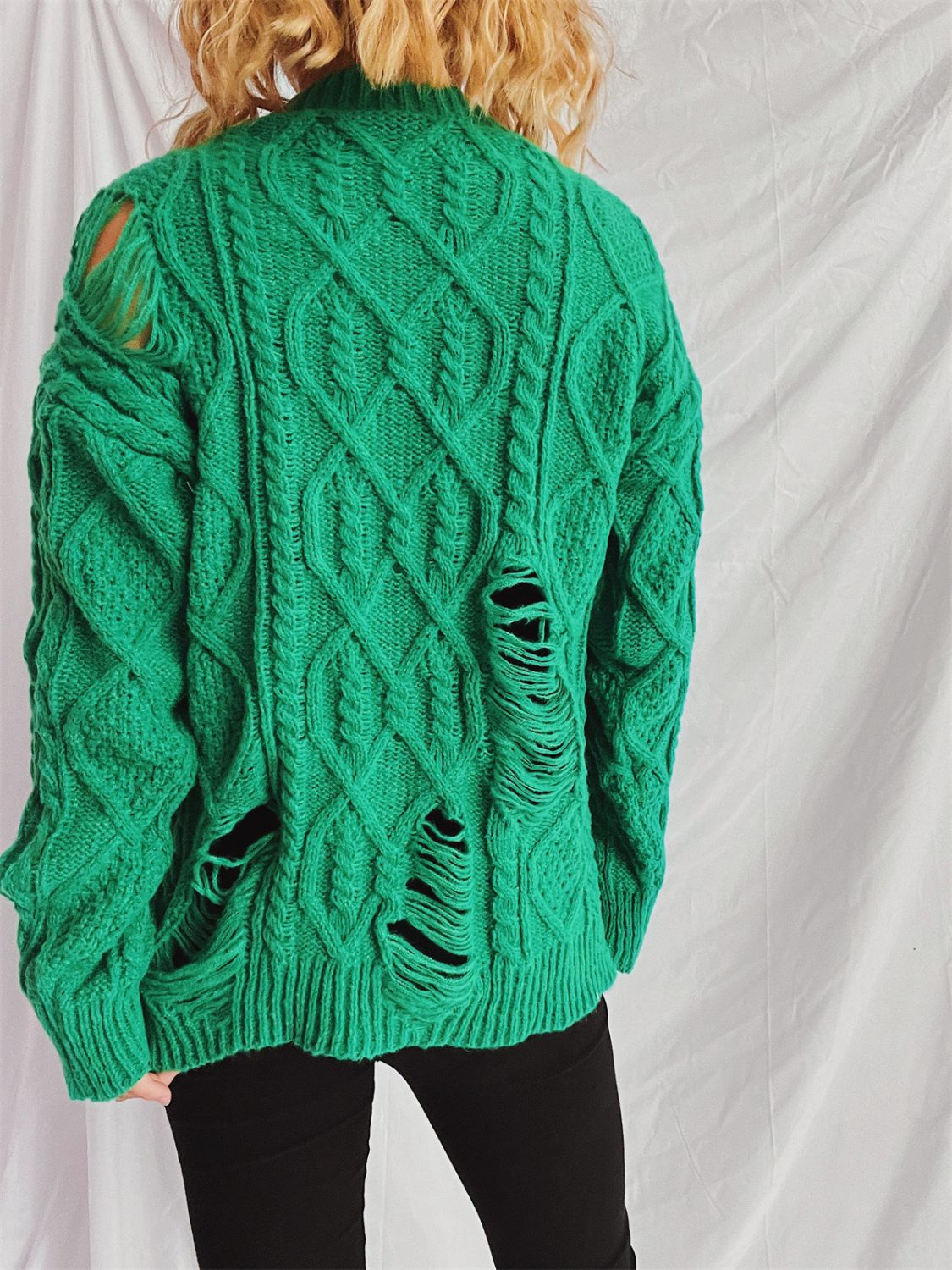 Distressed cable-knit round neck long sleeve sweater