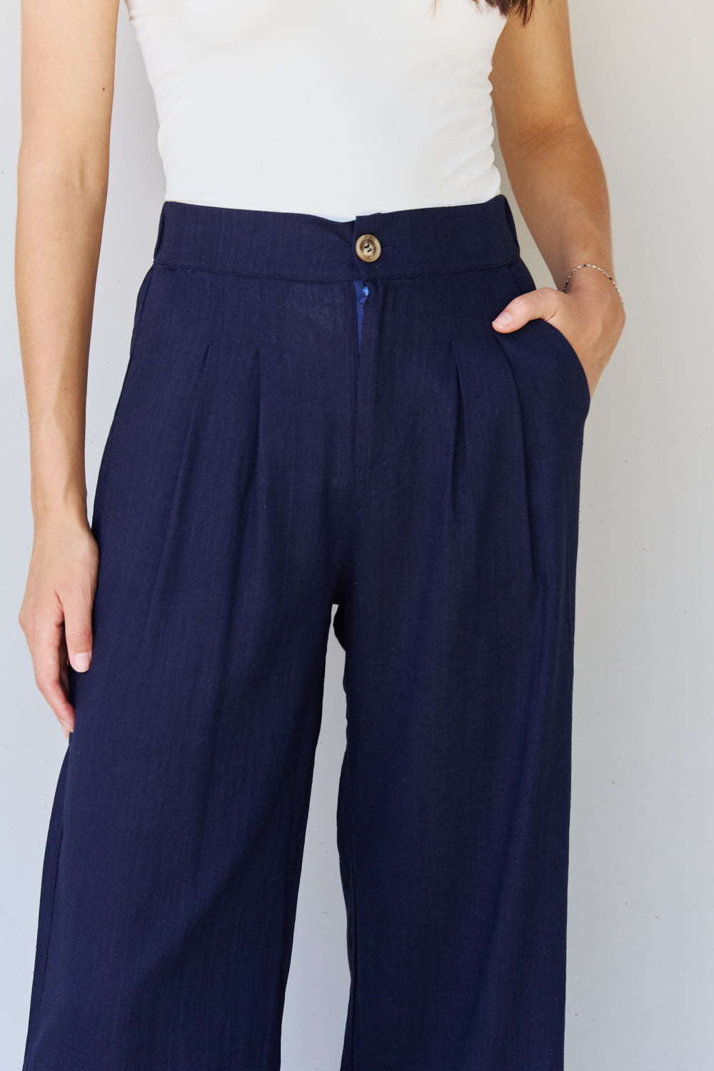 And the why in mix full size pleated detail linen pants in dark navy