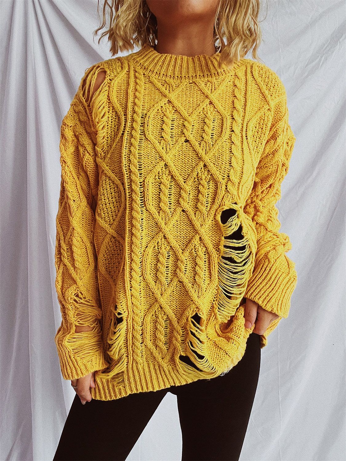 Distressed cable-knit round neck long sleeve sweater