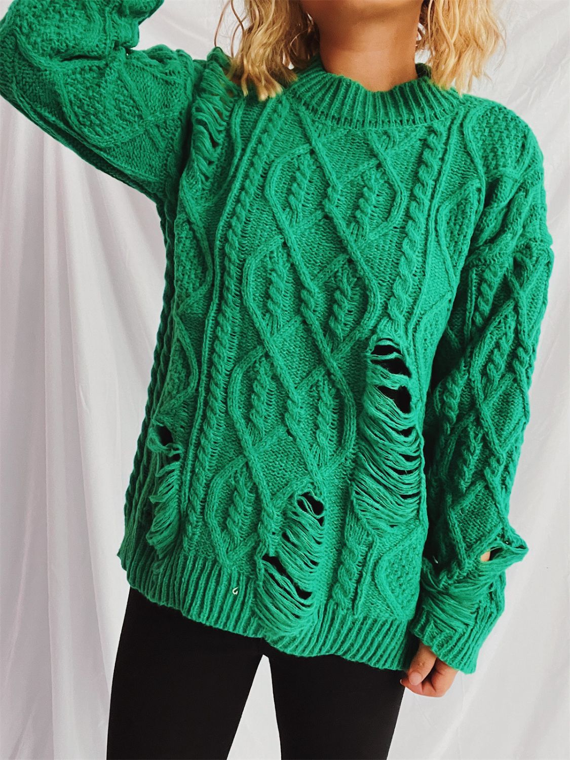 Distressed cable-knit round neck long sleeve sweater