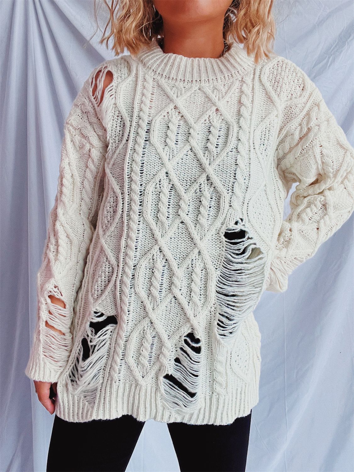 Distressed cable-knit round neck long sleeve sweater