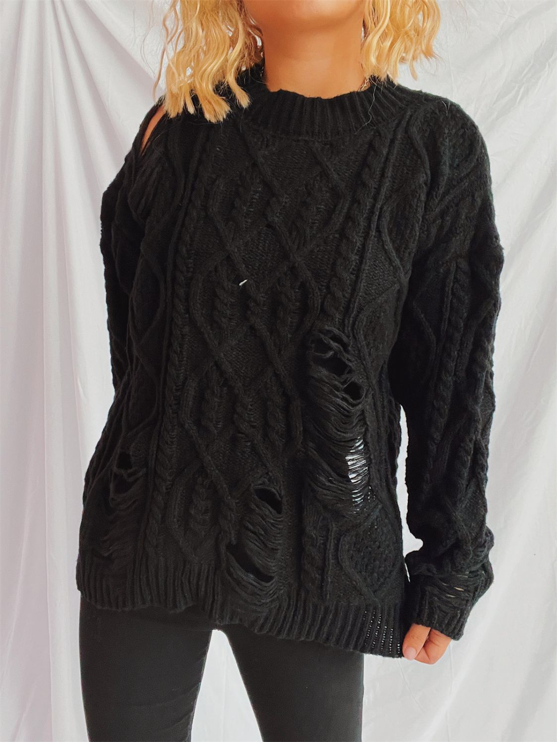 Distressed cable-knit round neck long sleeve sweater