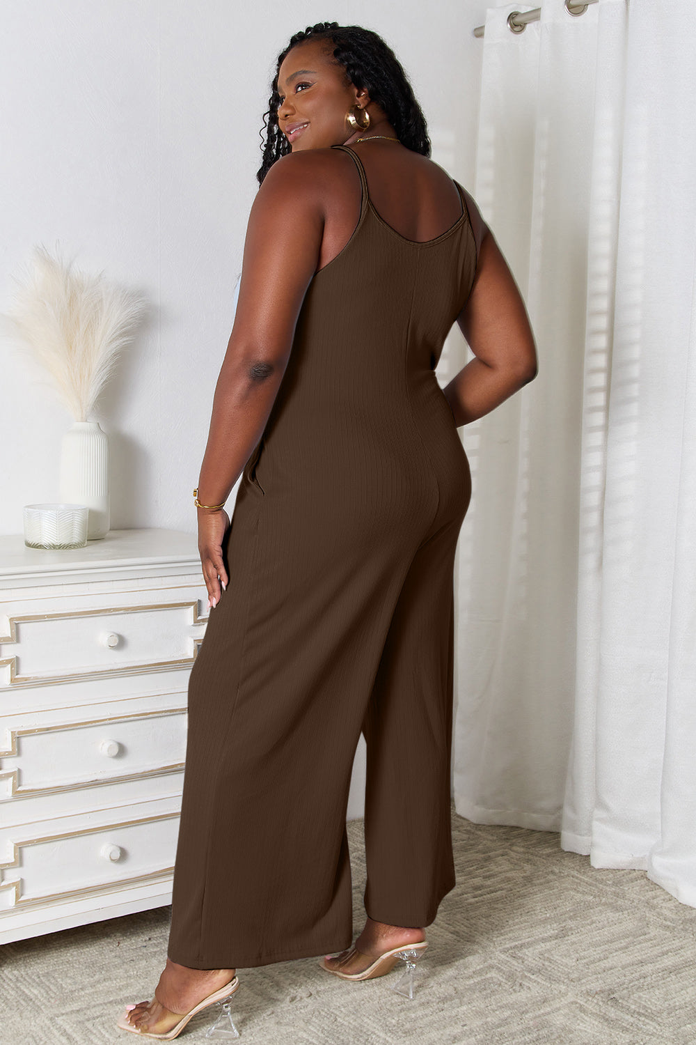 Brown sleeveless jumpsuit with wide-leg pants worn by a woman.