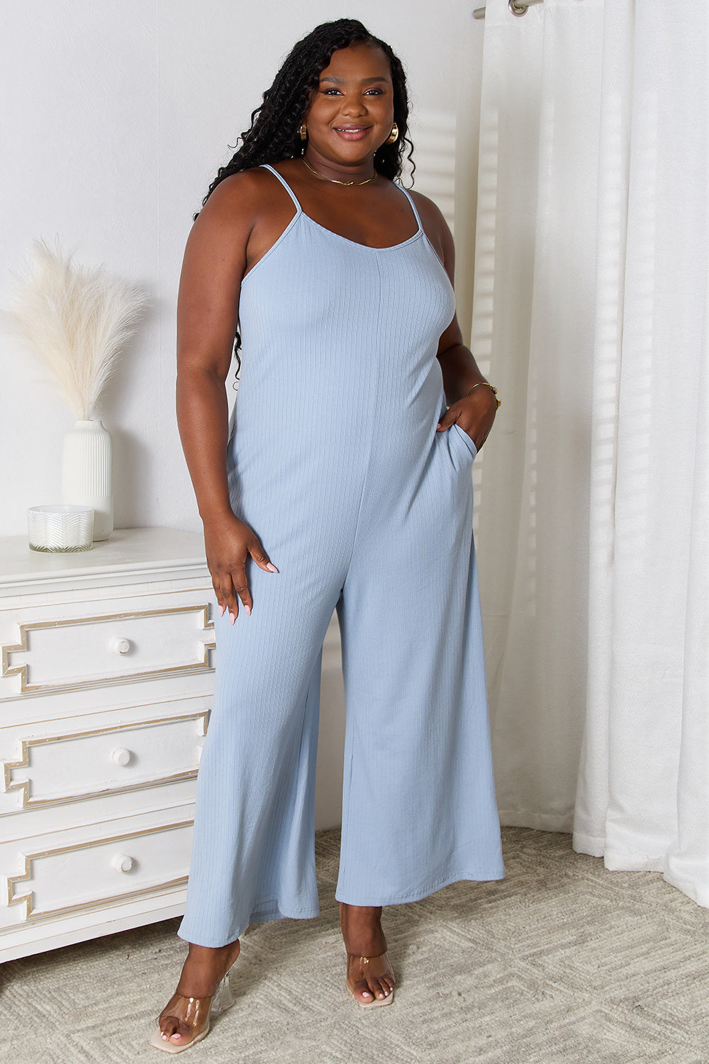 Light blue sleeveless jumpsuit with wide-leg pants.