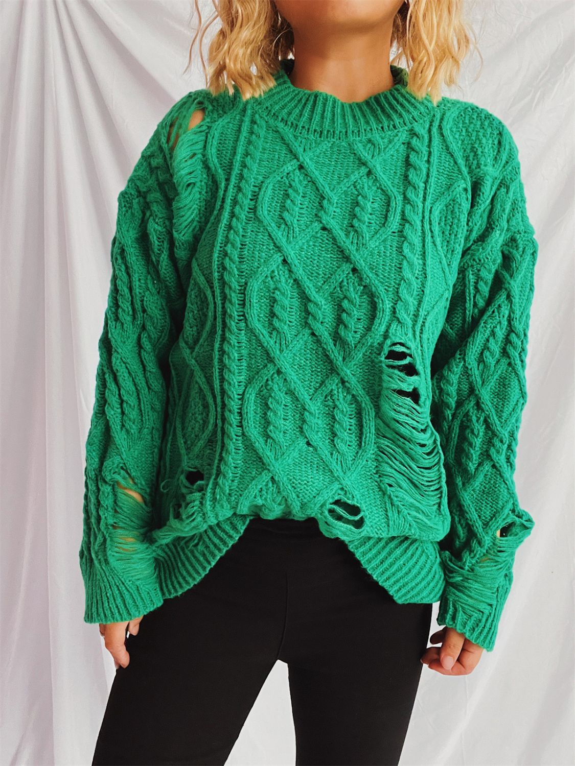 Distressed cable-knit round neck long sleeve sweater