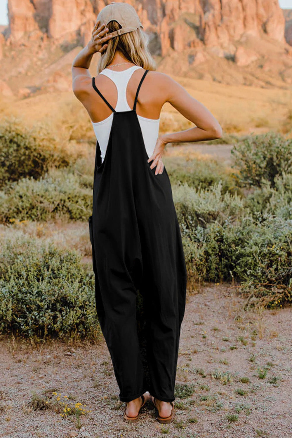 Woman wearing a black and white maxi dress standing with her back to the camera.