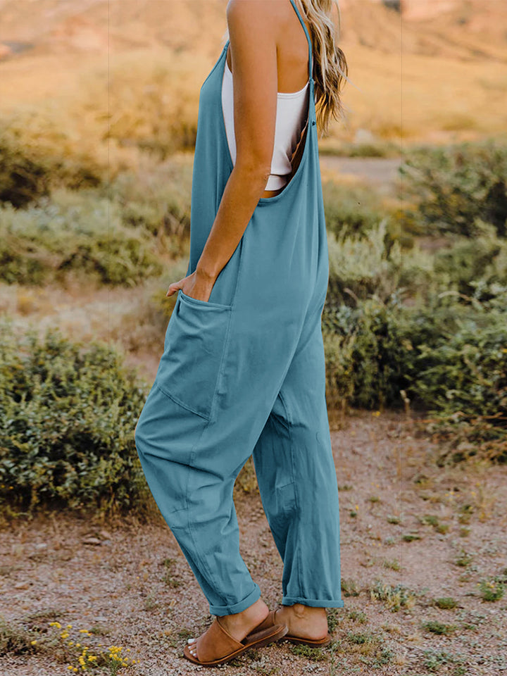 Loose-fitting blue jumpsuit or overalls with pockets and adjustable straps.