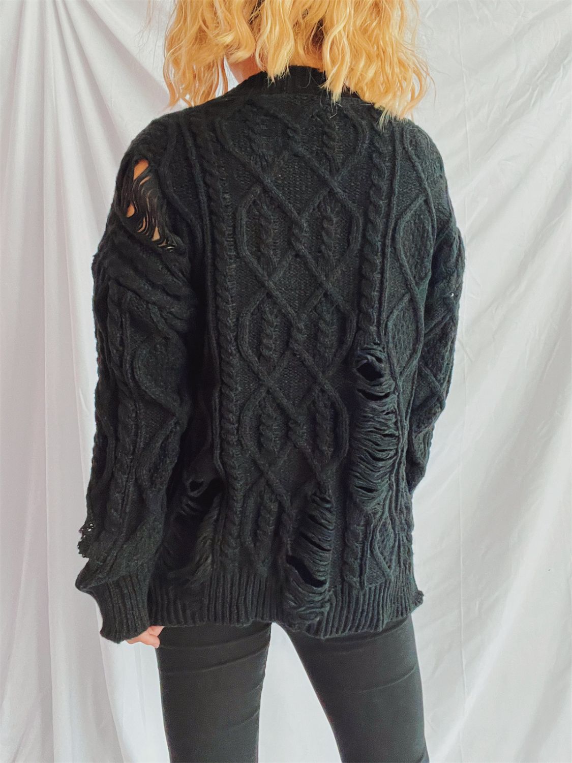 Distressed cable-knit round neck long sleeve sweater