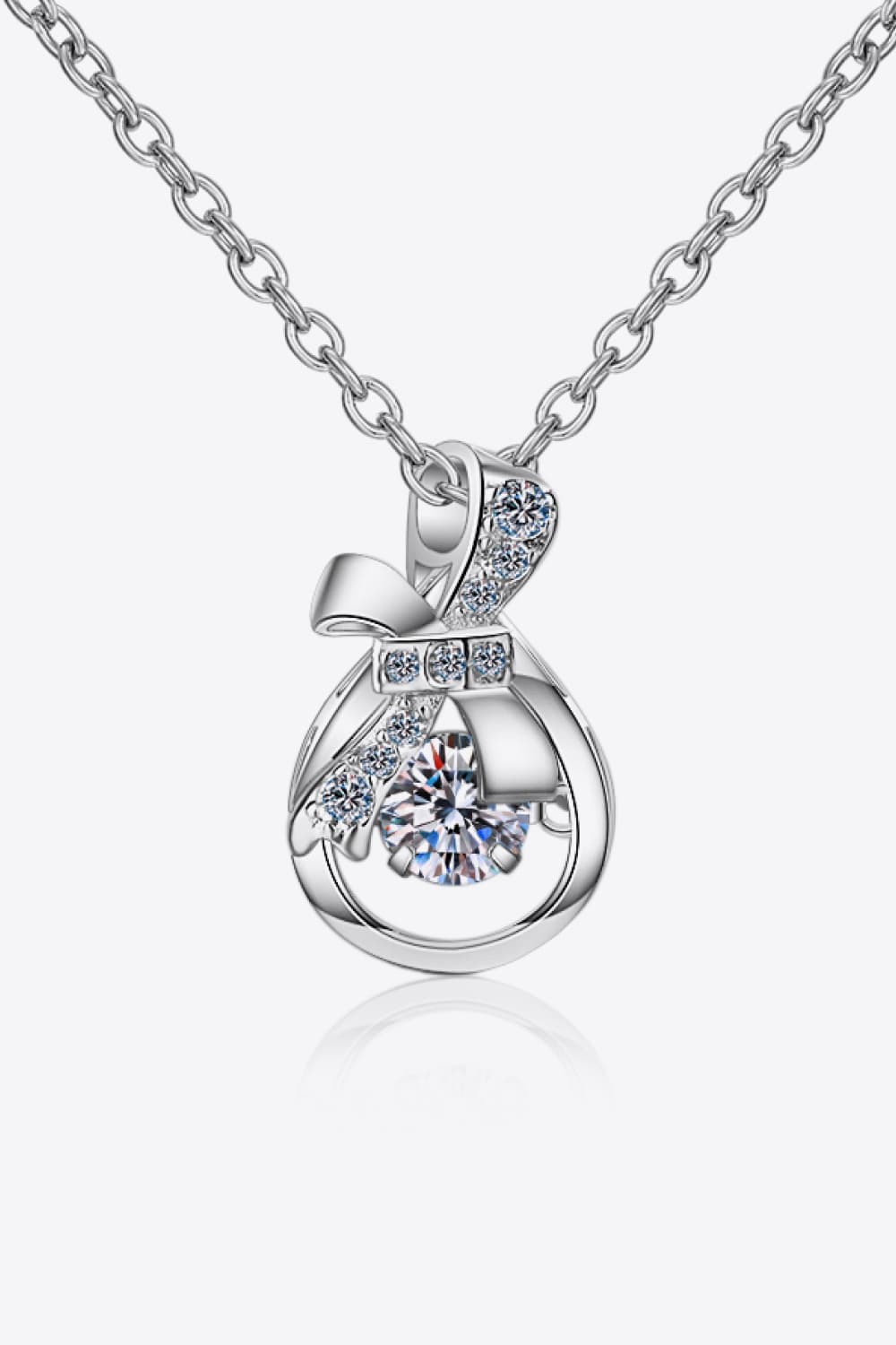 Elegant silver pendant necklace featuring a round diamond encircled by bow-like design - silver / one size