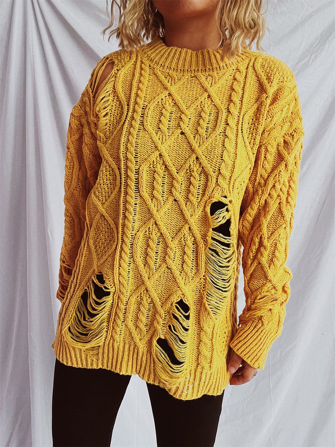 Distressed cable-knit round neck long sleeve sweater